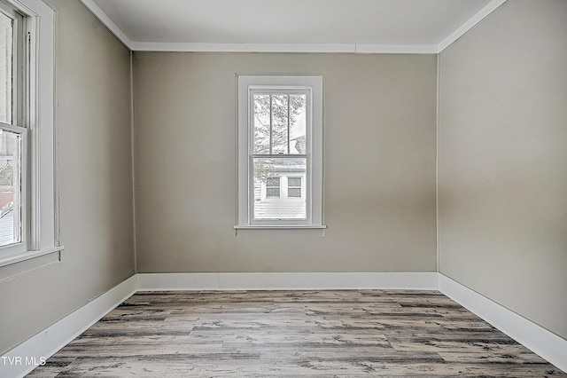 unfurnished room with crown molding and light wood-type flooring