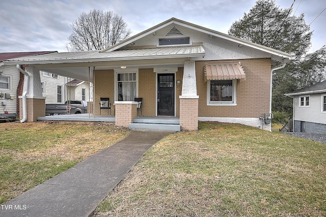 bungalow-style house featuring a front yard and covered porch