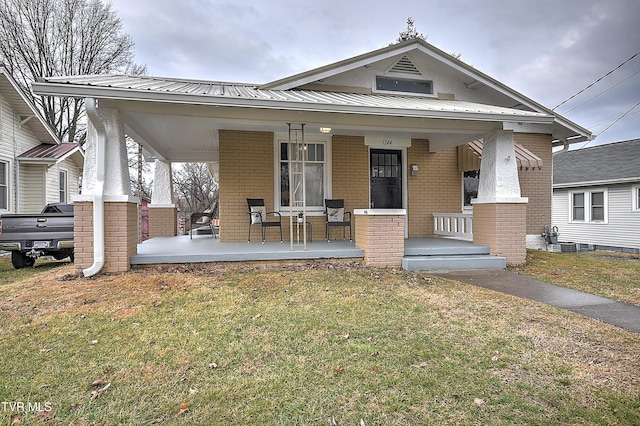 view of front of house featuring a front yard and a porch