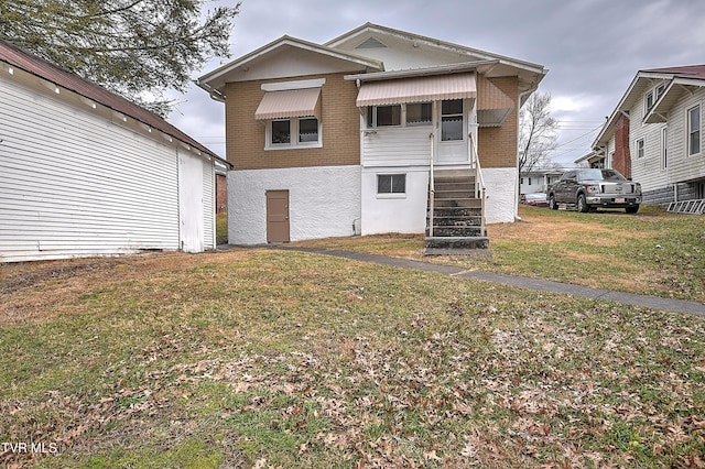 back of house with a yard