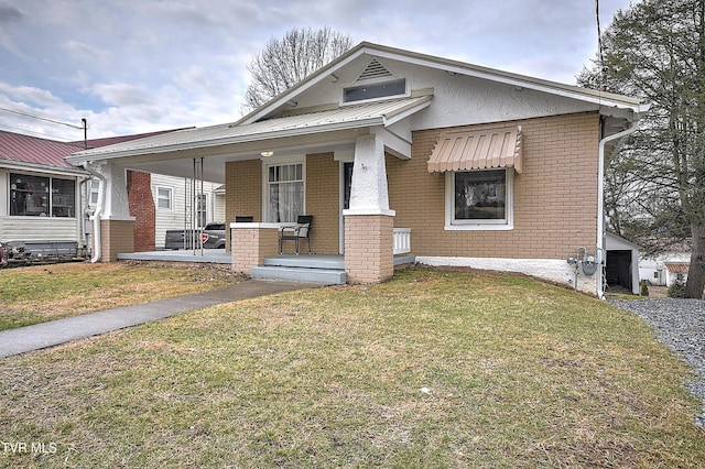 bungalow featuring a front yard and covered porch