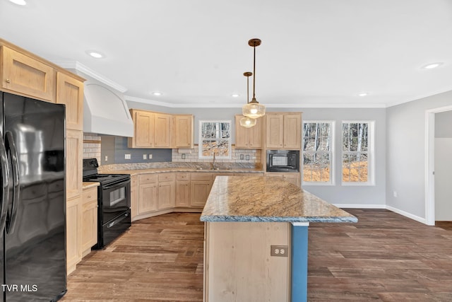 kitchen with crown molding, tasteful backsplash, black appliances, a kitchen island, and light brown cabinets