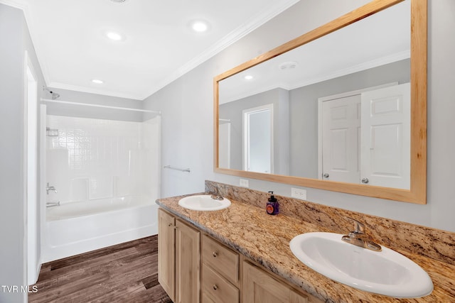 bathroom with hardwood / wood-style flooring, shower / washtub combination, vanity, and crown molding