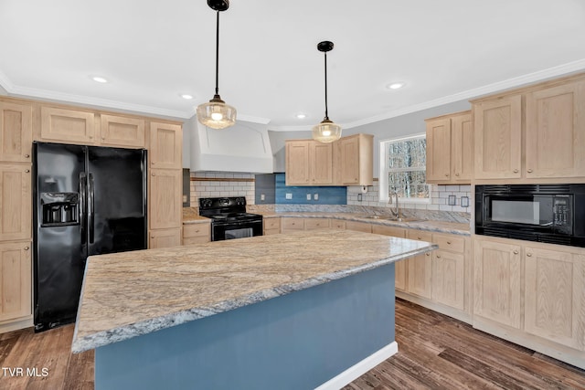 kitchen with sink, dark wood-type flooring, black appliances, and hanging light fixtures