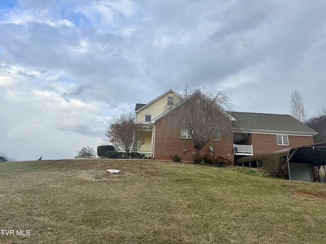 view of side of home with a lawn