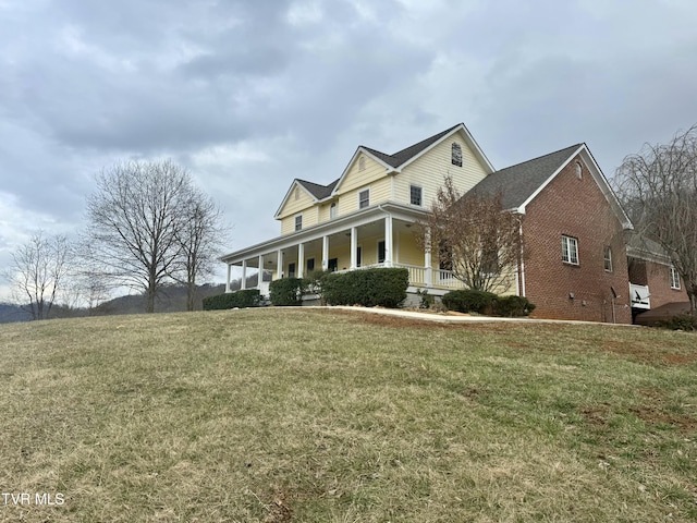 view of home's exterior featuring a porch and a yard