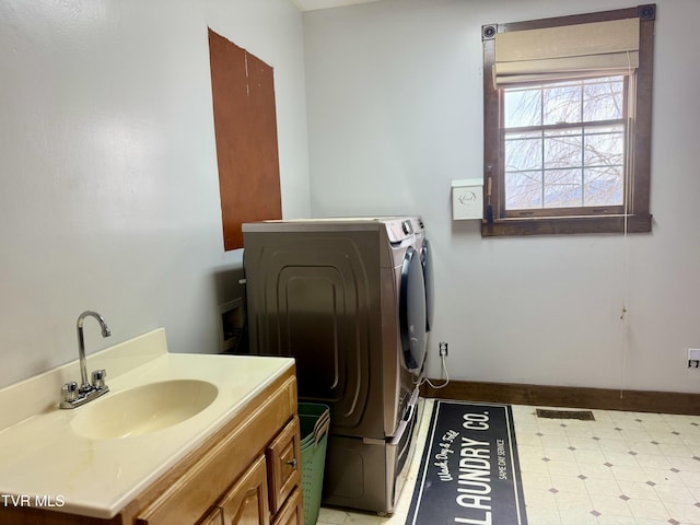 clothes washing area with sink and washer and dryer