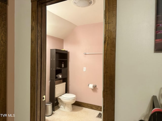 bathroom with toilet and vaulted ceiling