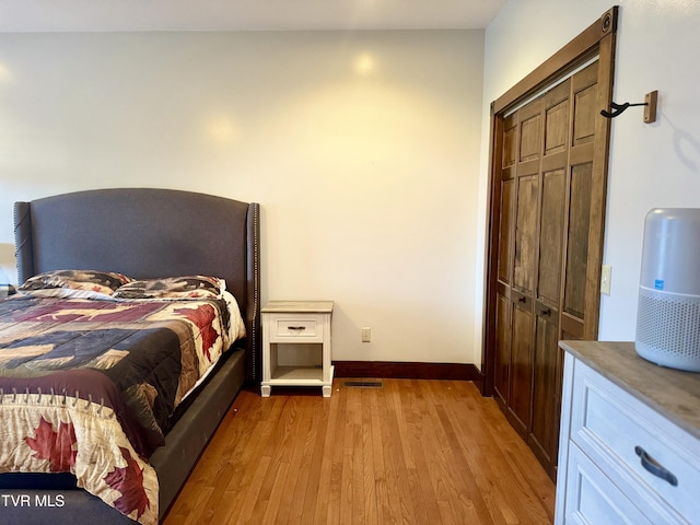 bedroom featuring light hardwood / wood-style floors and a closet