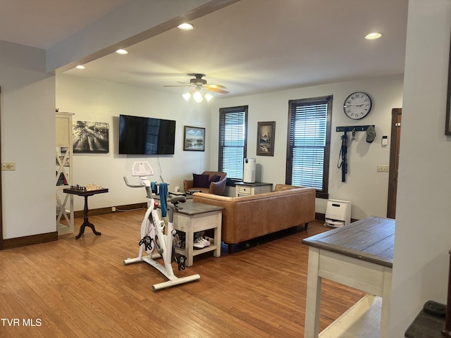 living room featuring ceiling fan and light hardwood / wood-style floors