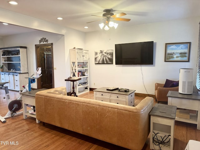 living room with hardwood / wood-style floors and ceiling fan