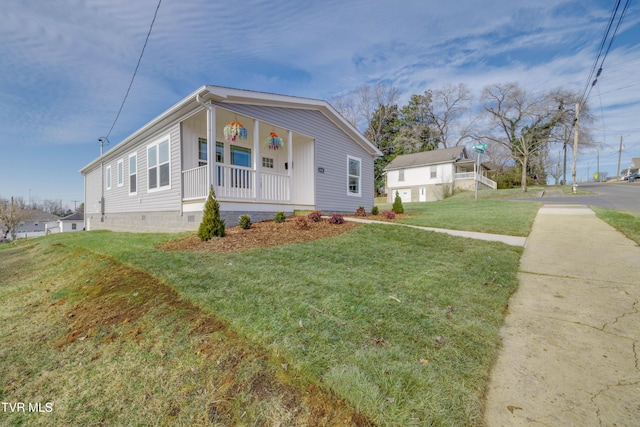 view of side of property featuring a porch and a yard