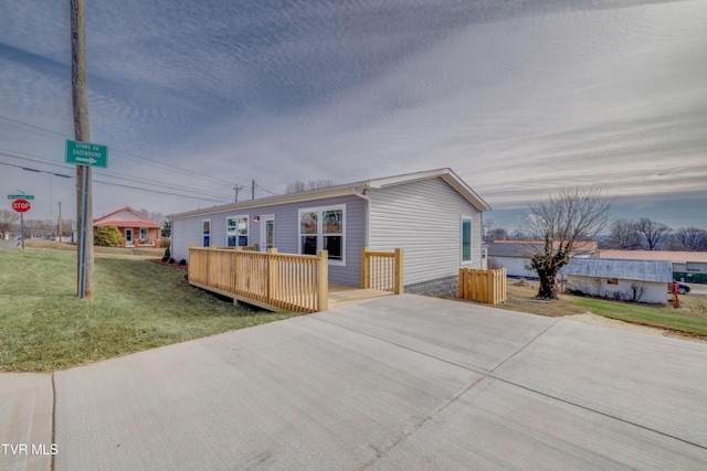 view of front facade featuring a yard and a deck