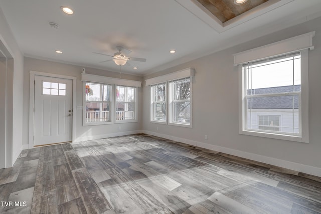 foyer with ceiling fan, ornamental molding, and wood-type flooring