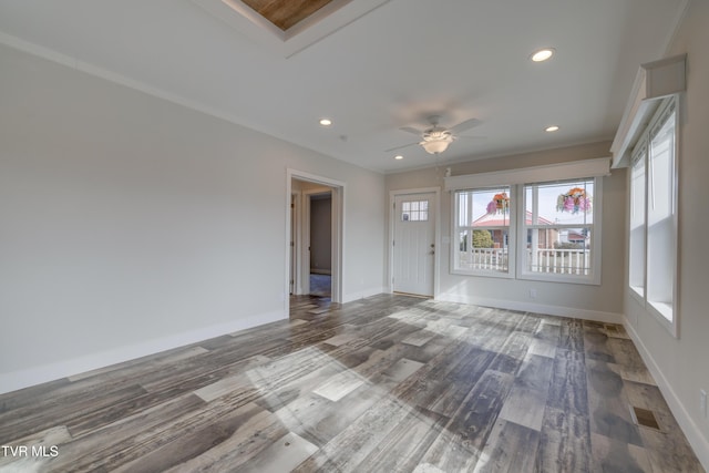 spare room featuring hardwood / wood-style floors, ornamental molding, and ceiling fan