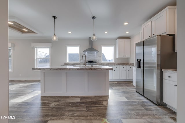 kitchen with white cabinetry, wall chimney exhaust hood, stainless steel fridge, and pendant lighting