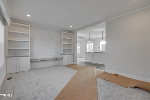 unfurnished living room featuring sink and light colored carpet