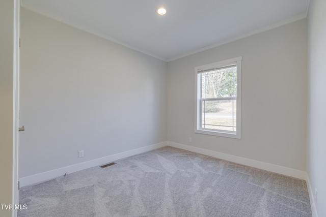 carpeted empty room featuring ornamental molding