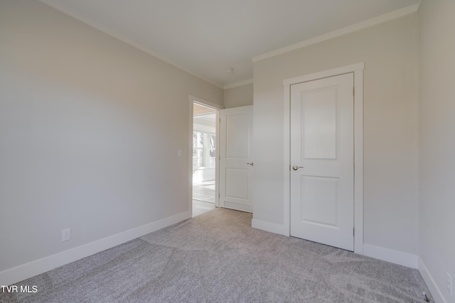 unfurnished bedroom featuring ornamental molding and light carpet