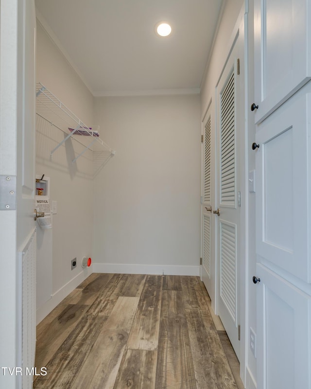 laundry room featuring ornamental molding, washer hookup, wood-type flooring, and hookup for an electric dryer