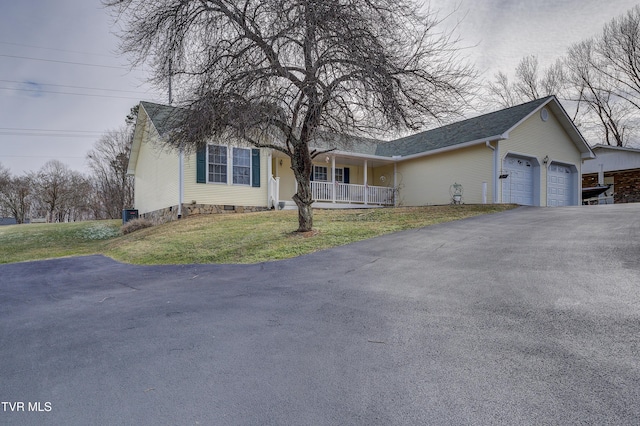 single story home with a garage, a front lawn, and covered porch