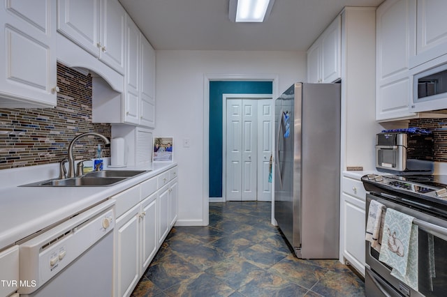 kitchen featuring backsplash, stainless steel appliances, sink, and white cabinets