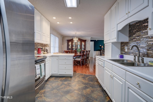 kitchen featuring tasteful backsplash, white cabinetry, sink, hanging light fixtures, and stainless steel appliances