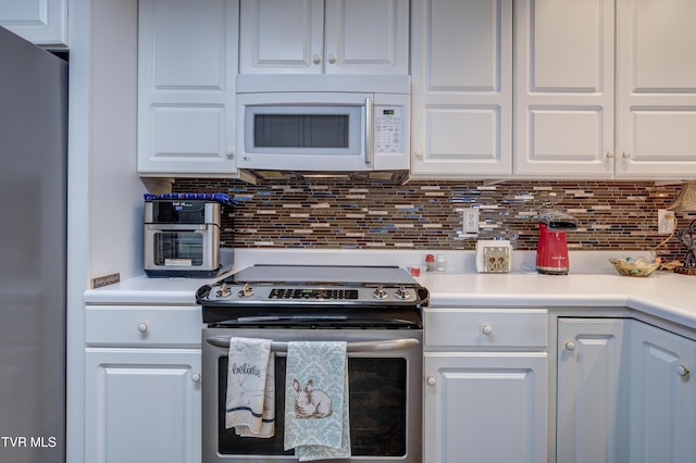 kitchen with white cabinetry, backsplash, and appliances with stainless steel finishes