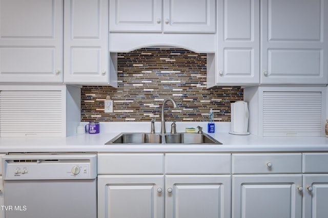 kitchen featuring white dishwasher, sink, decorative backsplash, and white cabinets