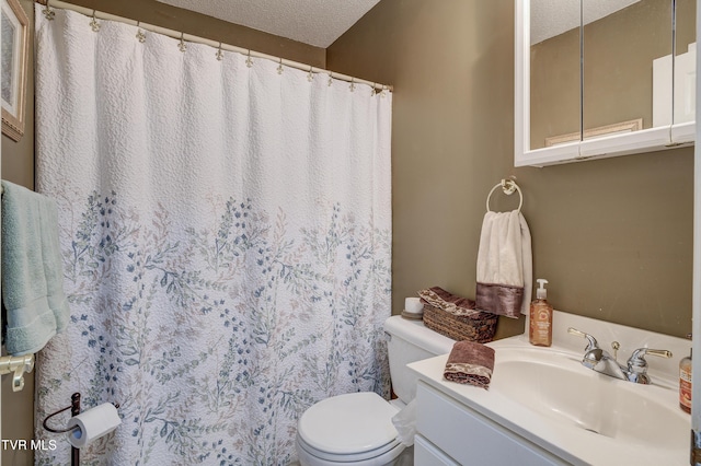 bathroom featuring vanity, toilet, and a textured ceiling