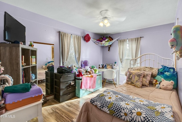 bedroom with hardwood / wood-style flooring and ceiling fan