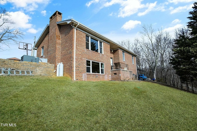 back of house with a lawn