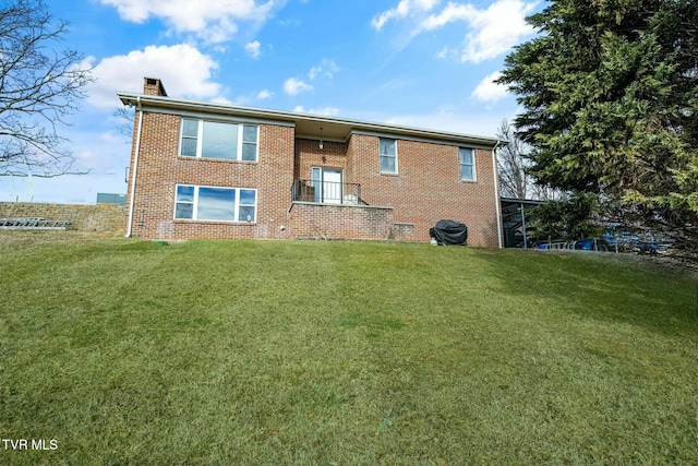 back of property featuring a lawn