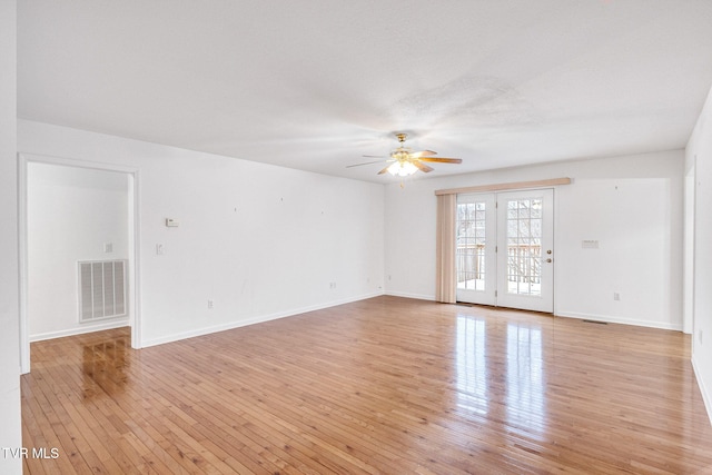 empty room featuring ceiling fan and light hardwood / wood-style flooring