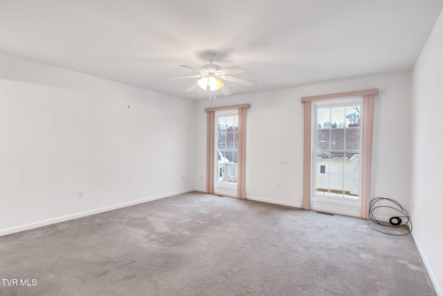 unfurnished room featuring ceiling fan and carpet