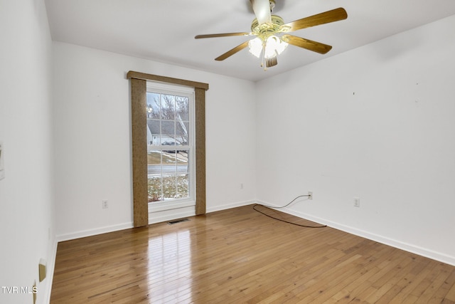 empty room featuring hardwood / wood-style flooring and ceiling fan