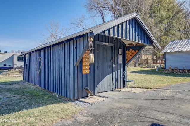 view of outbuilding featuring a lawn