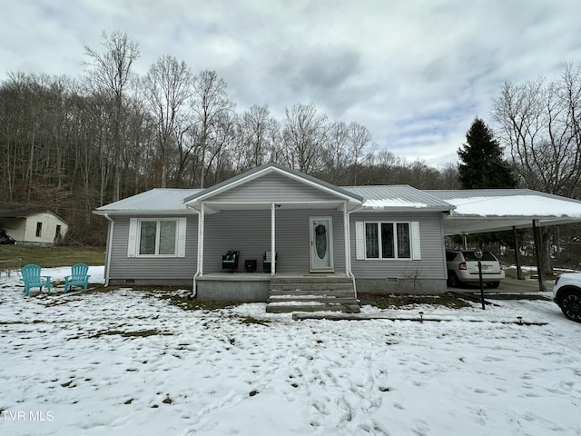 view of front of house with a carport and a porch