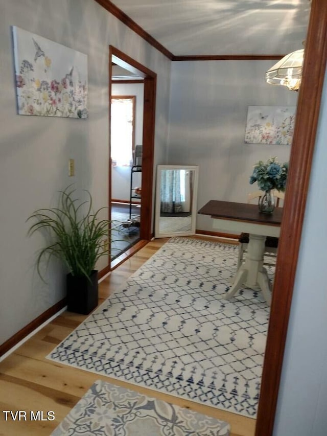 interior space with ornamental molding and hardwood / wood-style floors