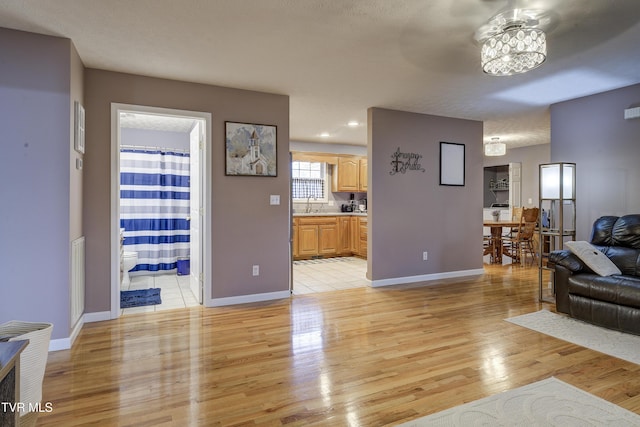 living room with sink and light hardwood / wood-style flooring