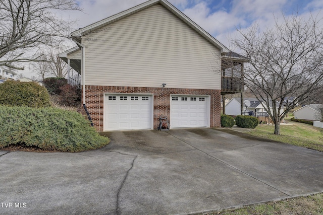 view of side of property with a garage and a balcony