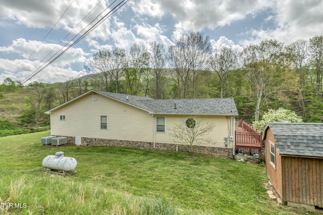 112 Conns Dr, Tazewell, VA 24651 - view of side of home with a storage shed, a deck, cooling unit, an outdoor structure, and a yard