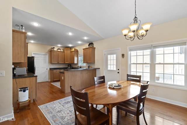 dining room with a notable chandelier, recessed lighting, baseboards, vaulted ceiling, and dark wood finished floors