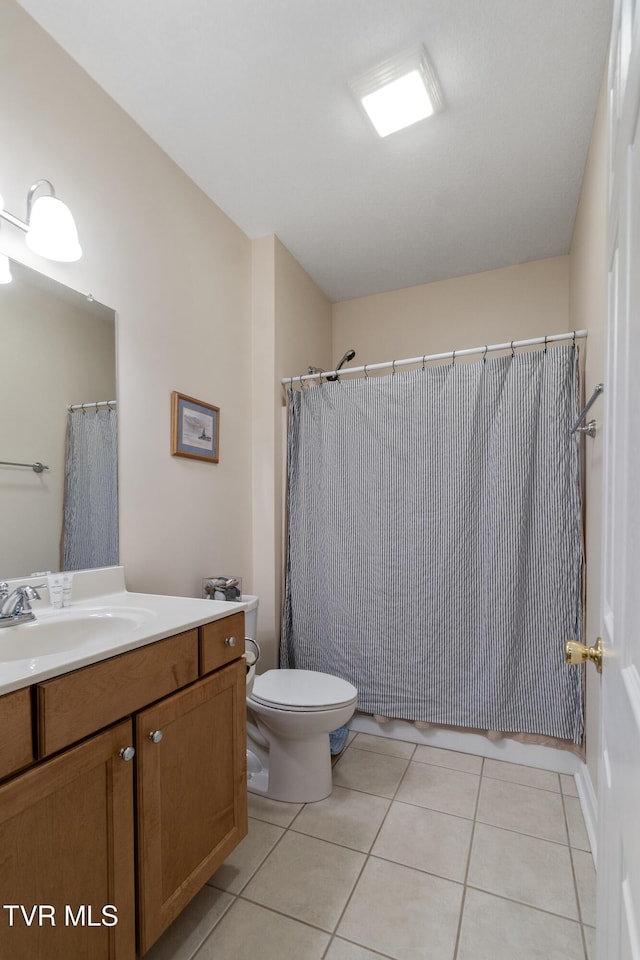 bathroom with vanity, tile patterned floors, and toilet