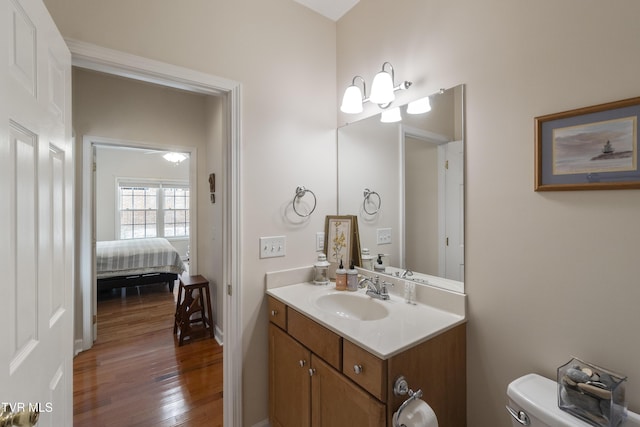 bathroom featuring hardwood / wood-style flooring, vanity, and toilet