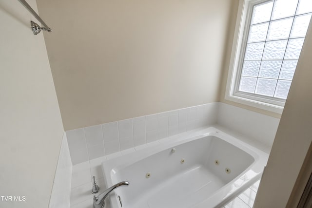 bathroom with a relaxing tiled tub