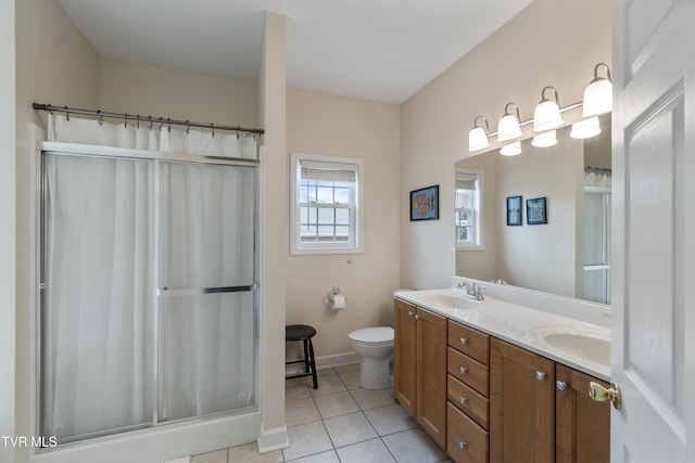 bathroom featuring vanity, toilet, tile patterned flooring, and a shower