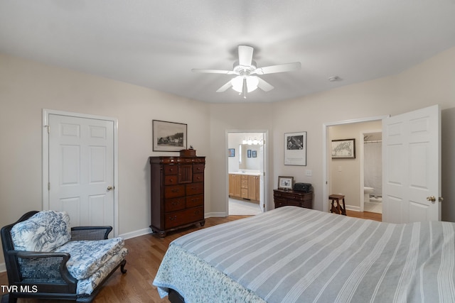 bedroom with hardwood / wood-style floors, connected bathroom, and ceiling fan