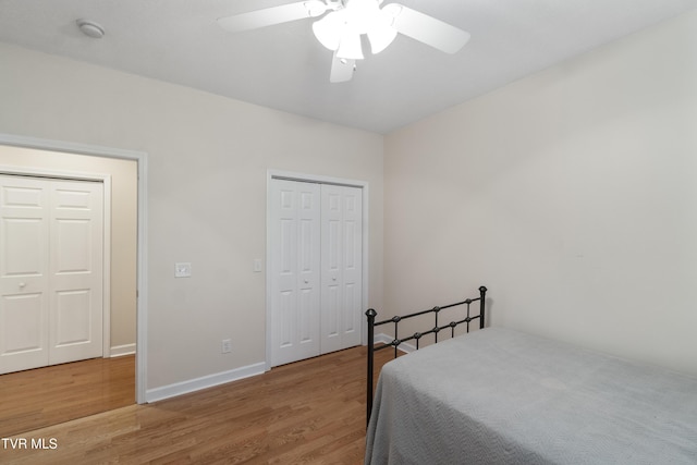 bedroom with hardwood / wood-style floors, ceiling fan, and a closet