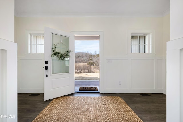 foyer featuring dark hardwood / wood-style flooring and crown molding